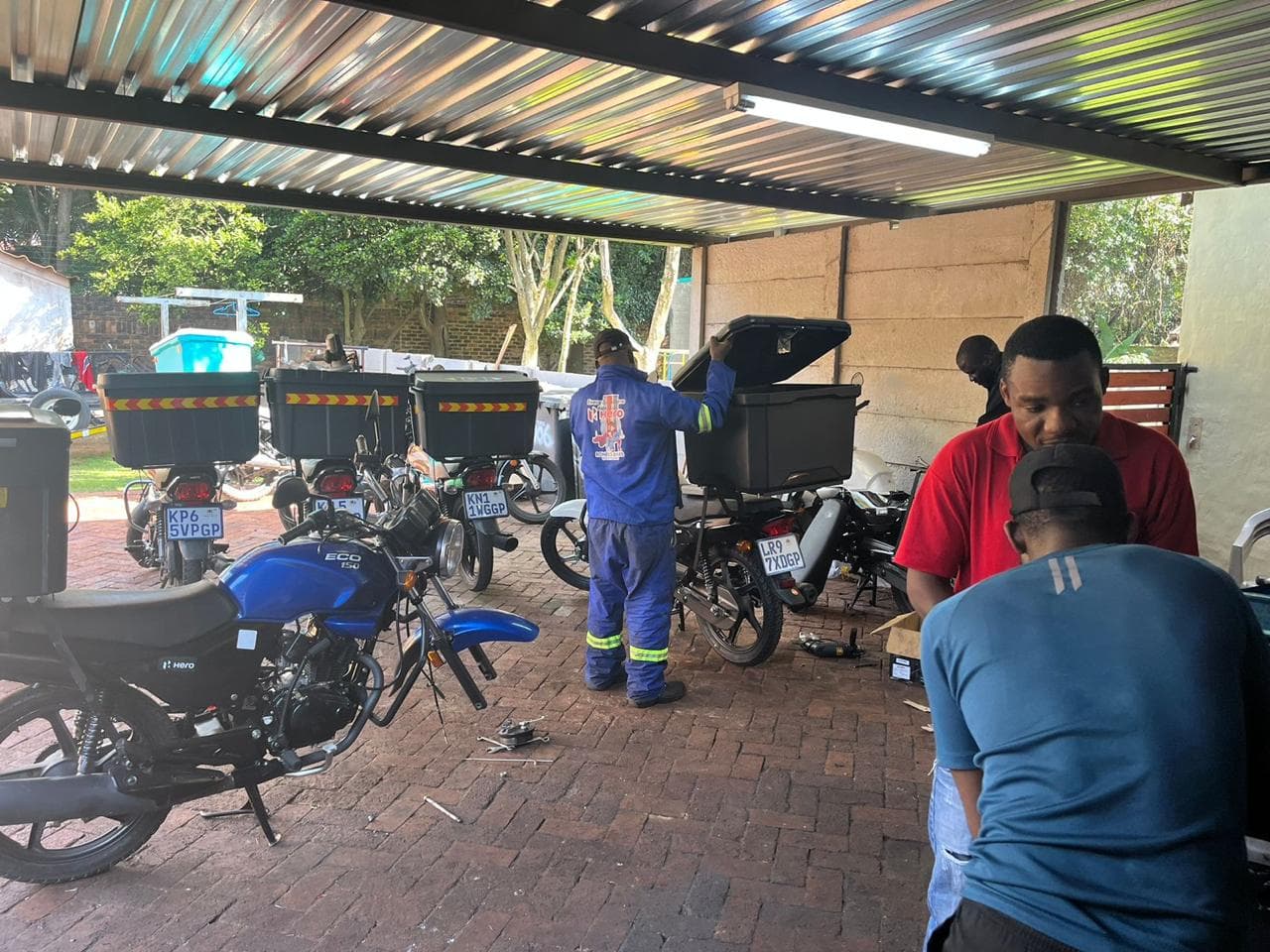 Technicians servicing a fleet of delivery bikes
