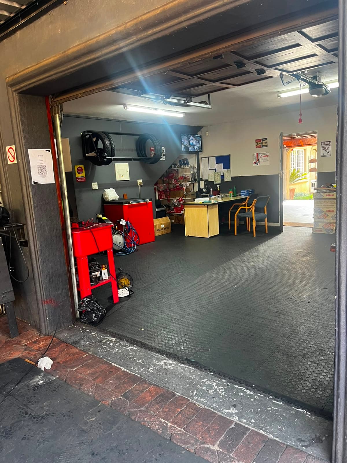 Workshop entrance, tyres and tooling on the wall